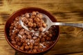 Cereal chocolate balls with milk in a bowl on wooden table. Spoon with breakfast Royalty Free Stock Photo