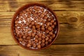 Cereal chocolate balls with milk in a bowl on wooden table. Top view