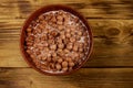 Cereal chocolate balls with milk in a bowl on wooden table. Top view Royalty Free Stock Photo