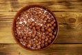 Cereal chocolate balls with milk in a bowl on wooden table. Top view Royalty Free Stock Photo