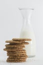 Cereal cookies and milk bottle on white background