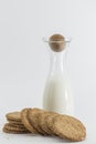 Cereal cookies and milk bottle on white background