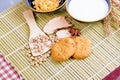 Cereal cookies milk in bowl Cornflakes spices on wooden bamboo and copy space. top view