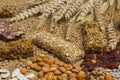 Cereal granola bars, nuts, raisins of wheat sprig on light wooden background Royalty Free Stock Photo