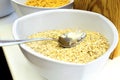 Cereal oatmeal in big bowl for self service dry quick breakfast food in hotel restaurant selection on white table Royalty Free Stock Photo