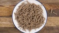 Cereal wheat fiber sticks. Dry healthy bran flake. Close up. Falling on a plate in slow motion.