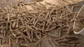 Cereal wheat flakes sticks fall from a cup in slow motion into a heap