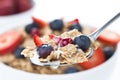 Cereals bowl with red fruits on white