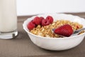 Cereals in bowl with strawberries and raspberries