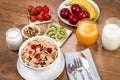 Cereals, fruits and yogurt on a wooden table for breakfast Royalty Free Stock Photo