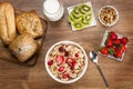 Cereals, fruits and yogurt on a wooden table for breakfast Royalty Free Stock Photo