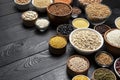 Cereals, grains, seeds and groats black wooden background Royalty Free Stock Photo