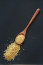 A cereals millet in wooden or bamboo spoon top view