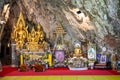 Ceremonial alms and kneeled monks inside Wat Tham Pha Plong Temple, Chiang Dao