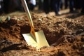 a ceremonial gold-painted spade for a groundbreaking