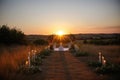 ceremony at sunset, with the golden glow of the sun casting a romantic and peaceful atmosphere