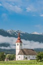 Cerkev in Bitnje, Slovenia at misty morning Royalty Free Stock Photo