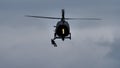 Helicopter rescues rescuer and injured person with winch on a bad weather day