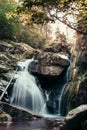 Cerny potok waterfall in Jizera mountains at sunset. A magical spectacle of the jewel of Czech nature. Clear water flows through