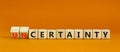 Certainty or Uncertainty symbol. Turned wooden cubes and changed concept words Uncertainty to Certainty. Beautiful orange