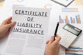 Certificat of liability insurance concept, documents on the desktop