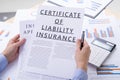 Certificat of liability insurance concept, documents on the desktop