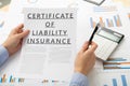 Certificat of liability insurance concept, documents on the desktop