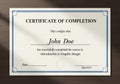 Certificate of Completion with a plain border on a wooden surface. It states \
