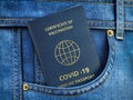 Certificate of vaccination, covid 19 immune passport in pocket of jeans