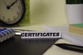 Certificates on the paper isolated on it desk. Business and inspiration concept