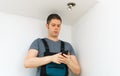 Man checking smart house light via smartphone Royalty Free Stock Photo
