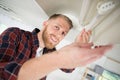 certified electrician installing light bulb Royalty Free Stock Photo