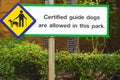 Certified guide dog sign for visually impaired on signpost in public park area