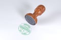 certified 100% Organic stamp with wooden rubber stamper Green color superior quality isolated on white background.