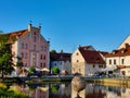 Beautiful riverbank of historical town Ceske Budejovice with pink hotel building which was a warehouse in the middle-ages