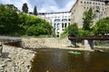 Cesky Krumlov, Czech Republic - August 11, 2013: Unidentified people in rubber raft and canoes on Moldau river in front of the