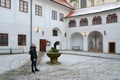 Girl - tourist is located in courtyard of public library in historic center of Cesky Krumlov, Czech Republic