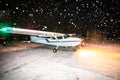 Cessna plane is preparing to fly in a snowstorm Royalty Free Stock Photo