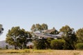 Cessna 172 airplane taking off from private airstrip