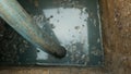 Cesspool septic emptying pumping into pipe tank by suction hose under high pressure. The sump contains pollution sludge Royalty Free Stock Photo