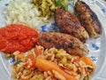 Cevapcici with ajvar, cucumbers, onions and Djuvec rice, Royalty Free Stock Photo