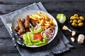 Cevapcici with potato fries, lettuce, onion, ajvar Royalty Free Stock Photo