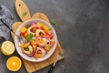 Ceviche salad with shrimps and oranges on a dark rustic background. Latin American food. Top view, flat lay, copy space Royalty Free Stock Photo