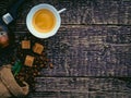 Cezve, a cup of coffee, a bag of spilled coffee beans and cane sugar lumps on an old wooden surface Royalty Free Stock Photo