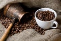 Cezve and cup with roasted coffee beans Royalty Free Stock Photo