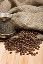 Cezve with freshly roasted coffee beans on table Royalty Free Stock Photo