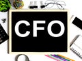 CFO Concept on drawing board with office tools