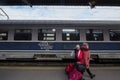 CFR Calatori logo on intercity train in Gara de Nord, main railway station of Bucharest with passengers passing by