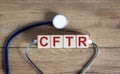 CFTR medical concept. Wooden cubes with the inscription `CFTR - cystic fibrosis transmembrane regulator`, stethoscope. Beautiful Royalty Free Stock Photo