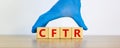 CFTR symbol. Wooden cubes with words `CFTR - cystic fibrosis transmembrane regulator`, doctor hand in blue glove. Beautiful whit Royalty Free Stock Photo